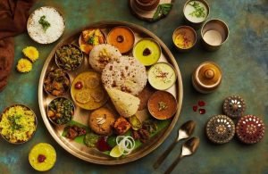 A vibrant Indian thali spread on a brass plate featuring soft chapatis, fluffy rice, an array of small bowls with colorful curries and chutneys, crisp papad, and sweet pongal—capturing the festive flair of engagement catering services near me Bangalore.